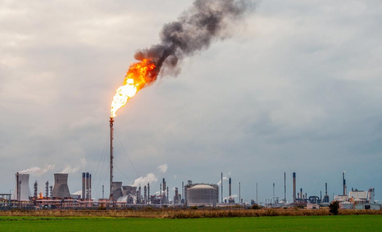 <p>Flames and smoke rising from a flare stack at Grangemouth oil refinery and petrochemical plant in Scotland</p> (Getty Images)