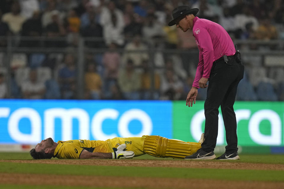 Australia's Glenn Maxwell lies on the ground as he struggles due to cramps during the ICC Men's Cricket World Cup match between Australia and Afghanistan in Mumbai, India, Tuesday, Nov. 7, 2023. (AP Photo/Rajanish Kakade)