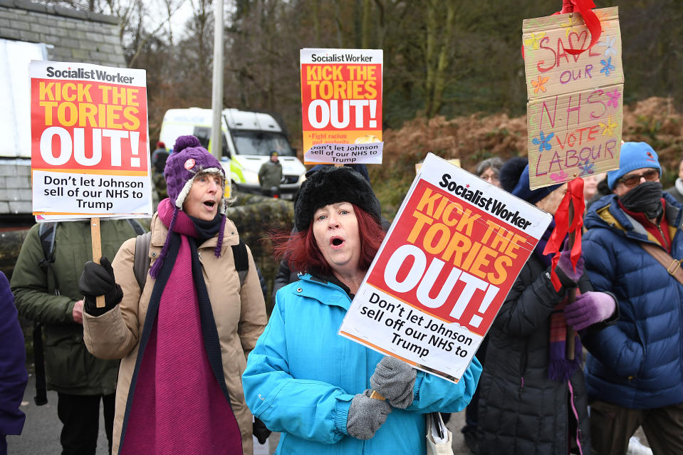 People protesting as Prime Minister Boris Johnson visits the John Smedley Mill Shop, while election campaigning in Matlock.