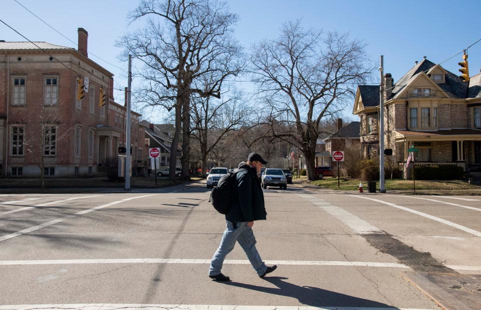 Jeff Cardin walks through downtown back to the Ross County Community Action Homeless Shelter on February 21, 2023 in Chillicothe, Ohio. Cardin has been homeless since November 2022 and has been living at the emergency shelter.