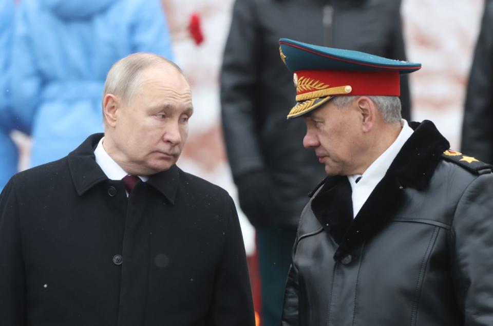 Vladimir Putin (L) listens to Sergei Shoigu (R) while taking part in the wreath-laying ceremony at the Unknown Soldier Tomb, marking the Defender of the Fatherland's Day in Moscow, Russia, on Feb. 23, 2024. (Contributor/Getty Images)