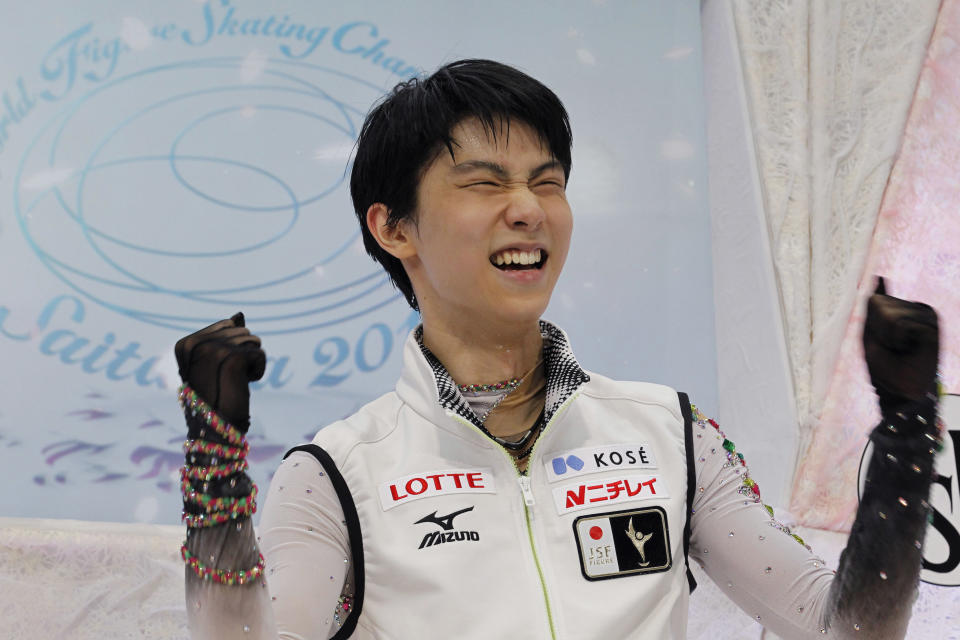 Yuzuru Hanyu of Japan reacts to his victory in the men's free skating finals of the World figure skating championships in Saitama near Tokyo, Friday, March 28, 2014. Hanyu barely topped the free skate to become the first man in 12 years on Friday to win the Olympic and world figure skating titles in the same year. (AP Photo/Koji Sasahara)