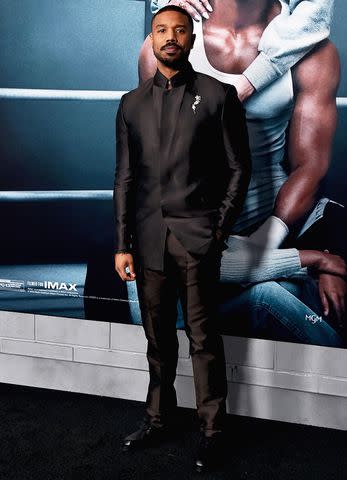 <p>Alberto E. Rodriguez/WireImage</p> Michael B. Jordan in front of a Creed poster