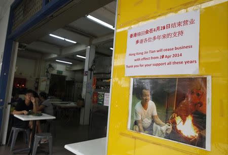 A man eats a meal at the Hong Kong Jin Tian Eating House in Singapore April 17, 2014. REUTERS/Edgar Su