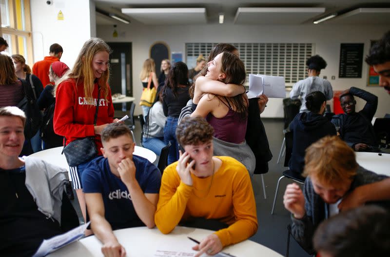 Sixth form students react as they receive their A-Level results at Stoke Newington School in London