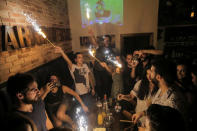 People celebrate friend's birthday in Marionette bar in the Old City of Damascus, Syria, September 13, 2018. For much of the war the eastern Ghouta rebels fired mortars into Damascus, including the Old City, where shrapnel marks are often visible scored into streets or walls. Cafes spill out onto the cobbled streets of the Old City at night as carefully coiffed barbers give fashionable haircuts to young men, and groups of friends gather to play guitars. REUTERS/Marko Djurica