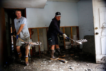 People clean their house after the passing of Hurricane Florence in New Bern, North Carolina, U.S., September 16, 2018. REUTERS/Eduardo Munoz