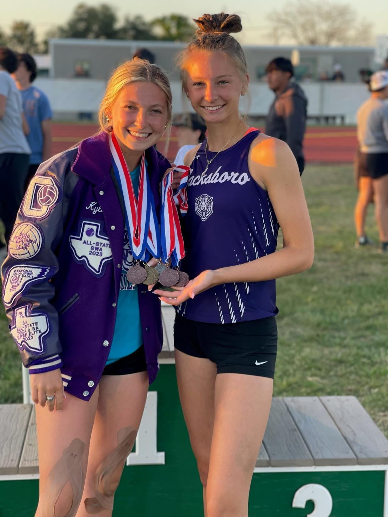 Jacksboro sisters Kylie (left) and Brailyn Tullous pose with the medals they won at a track meet earlier this year.