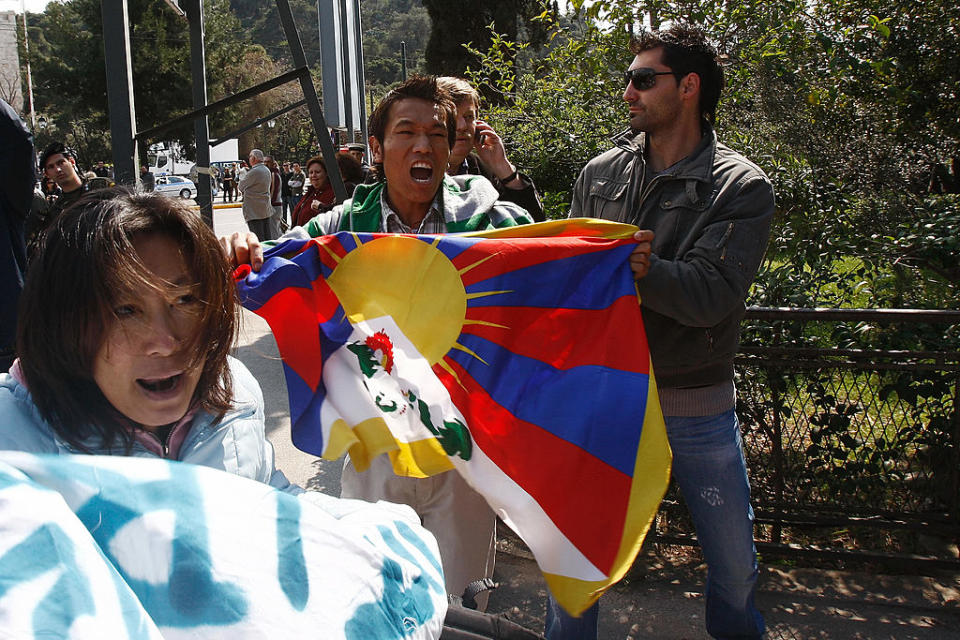 Pro-Tibetan demonstrators, holding a tibetan flag, are detained by plain clothes Greek policemen as they protest and shout anti-Chinese slogans during the handover ceremony of the Olympic flame to China on March 30, 2008 outside the Panathinaiko stadium in Athens.<span class="copyright">Kostas Souliotis/AFP via Getty Images</span>