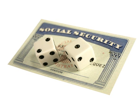 Social Security card with two dice on top.