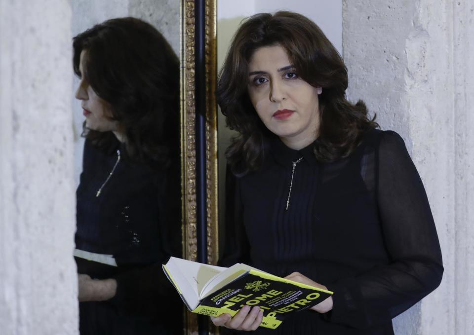 PR agent Francesca Chaouqui holds her book 'In the Name of Peter' (Nel Nome di Pietro), a behind-the-scenes drama of a papal reform commission that ended in disgrace after its documents were leaked to two journalists, during an interview with the Associated Press, in Rome, Monday, Feb. 6, 2017. Chaouqui received a suspended sentence for her role in the leaks, and is tempting Vatican prosecutors by publishing confidential documents in her book that hits bookstores Tuesday (AP Photo/Andrew Medichini)