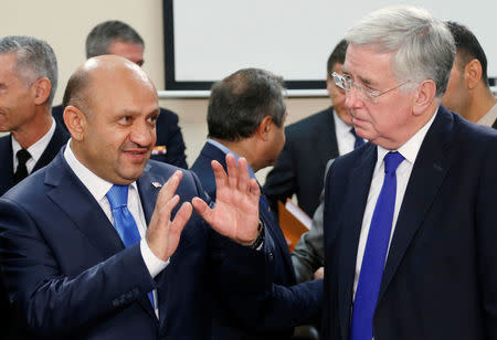 Turkey's Defense Minister Fikri Isik talks to Britain's Defence Secretary Michael Fallon (R) during a NATO defence ministers meeting at the Alliance headquarters in Brussels, Belgium, October 26, 2016. REUTERS/Francois Lenoir