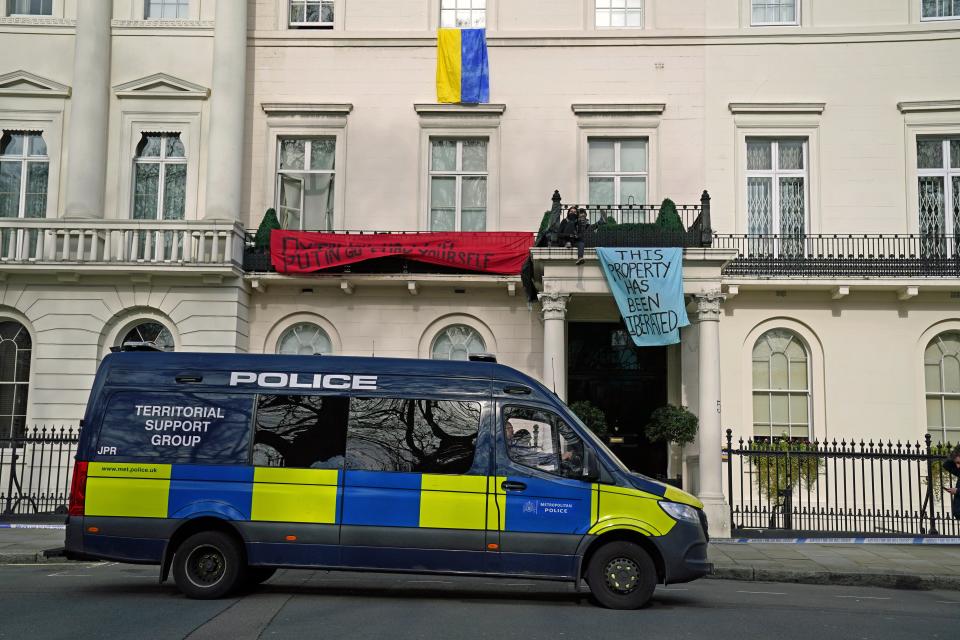 Officers from the Metropolitan Police Territorial Support Group watch over a group of squatters occupying a mansion belonging to Russian oligarch Oleg Deripaska in central London. (PA Wire)