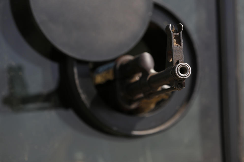 A weapon is pointed out of a military vehicle as forces loyal to Abdul Hamid Dbeibah, one of Libya’s two rival prime ministers, secure the streets of the capital, Tripoli, Tuesday May, 17, 2022. Clashes broke out in Tripoli after Dbeibah’s rival, Prime Minister Fathi Bashagha, announced his arrival in the city on Tuesday morning. But Bashagha left soon after the fighting started. (AP Photo/Yousef Murad)