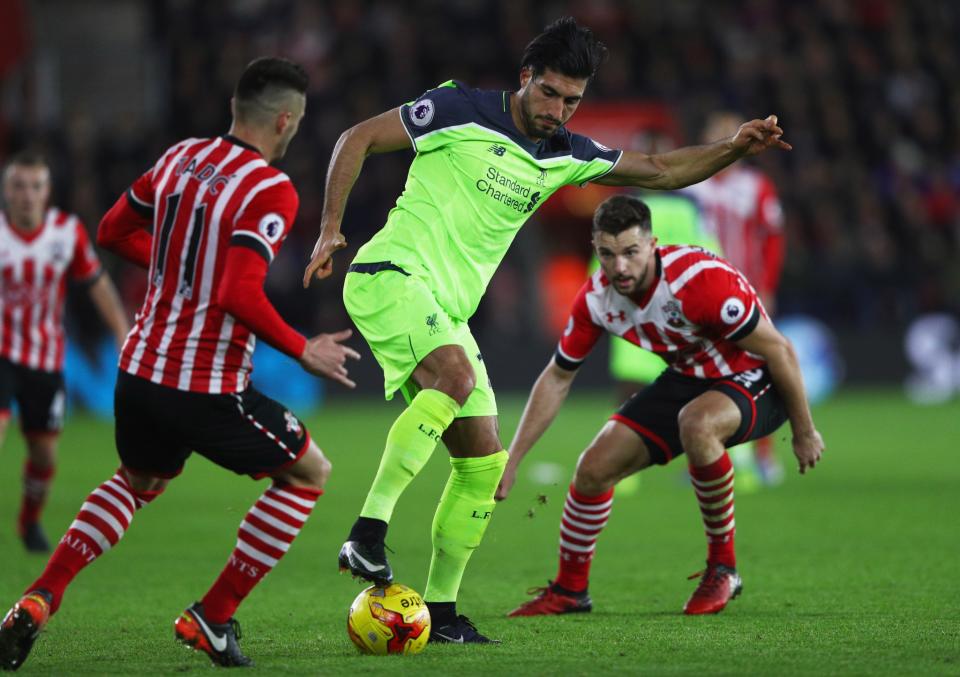 <p>Emre Can tries to wriggle out of a tight spot (Getty Images) </p>