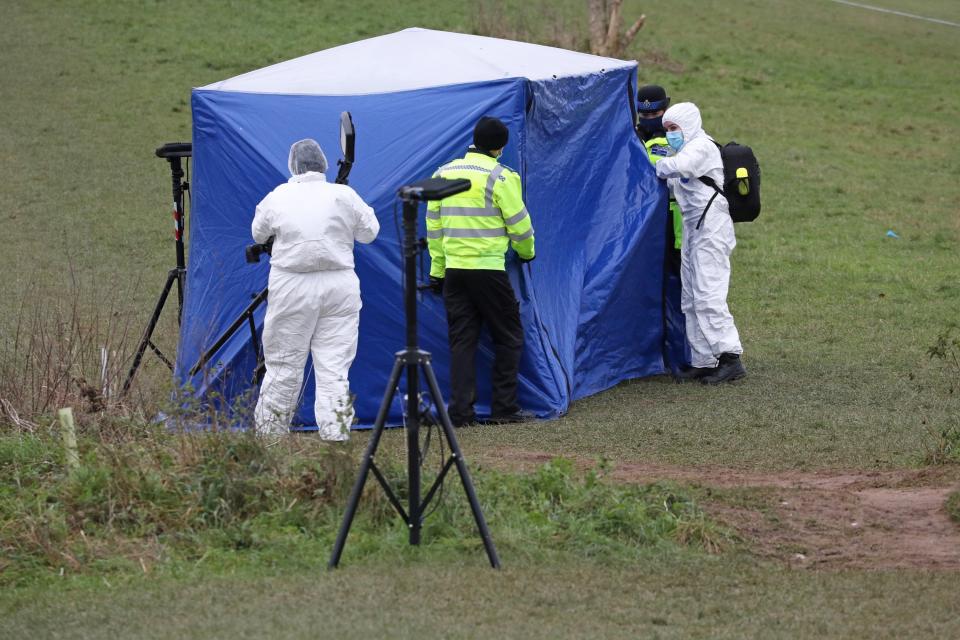 Investigators at a forensic tent in Bugs Bottom field, Emmer Green, where Olly was killed (PA)