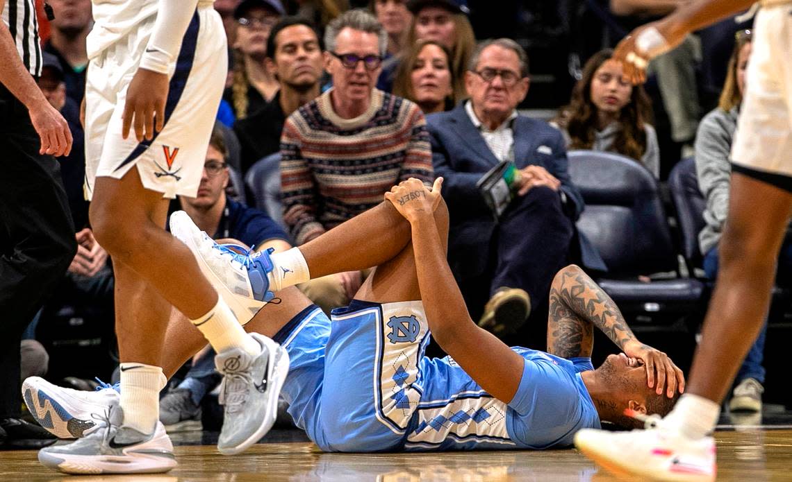 North Carolina’s Armando Bacot (5) grimaces in pain after injuring his left ankle in the opening minutes of play against Virginia on Tuesday, January 10, 2023 at John Paul Jones Arena in Charlottesville, Va.