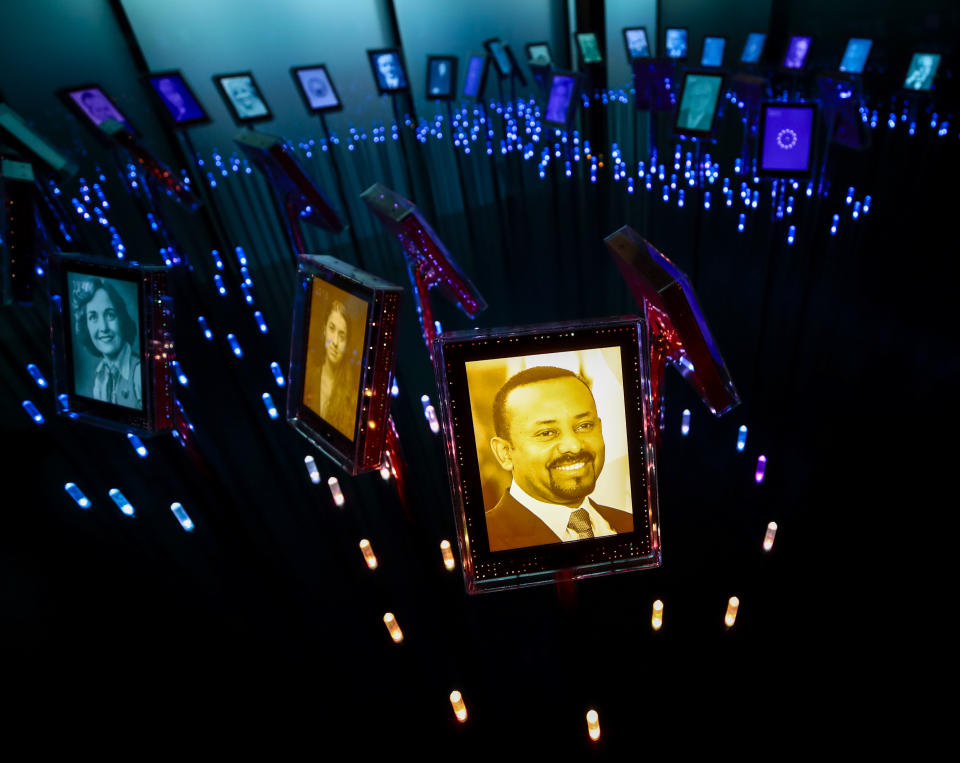 FILE - In this Friday, Oct. 11, 2019, file photo, a photograph of Ethiopian Prime Minister Abiy Ahmed, who was awarded the Nobel Peace Prize, is displayed with past Nobel Peace Prize winners, in their own "garden" at the Nobel Peace Center in Oslo, Norway. Ahmed left Ethiopians breathless when he became the prime minister in 2018, introducing a wave of political reforms in the long-repressive country and announcing a shocking peace with enemy Eritrea. Now, Abiy is waging war in the defiant Tigray region. (Lise Aserud/NTB Scanpix via AP, File)