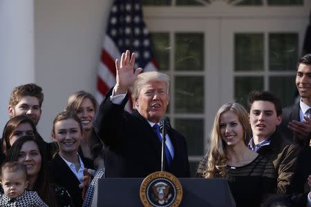 U.S. President Donald Trump waves in the White House Rose Garden while addressing the annual March for Life rally, taking place on the nearby National Mall in Washington, U.S., January 19, 2018. REUTERS/Kevin Lamarque