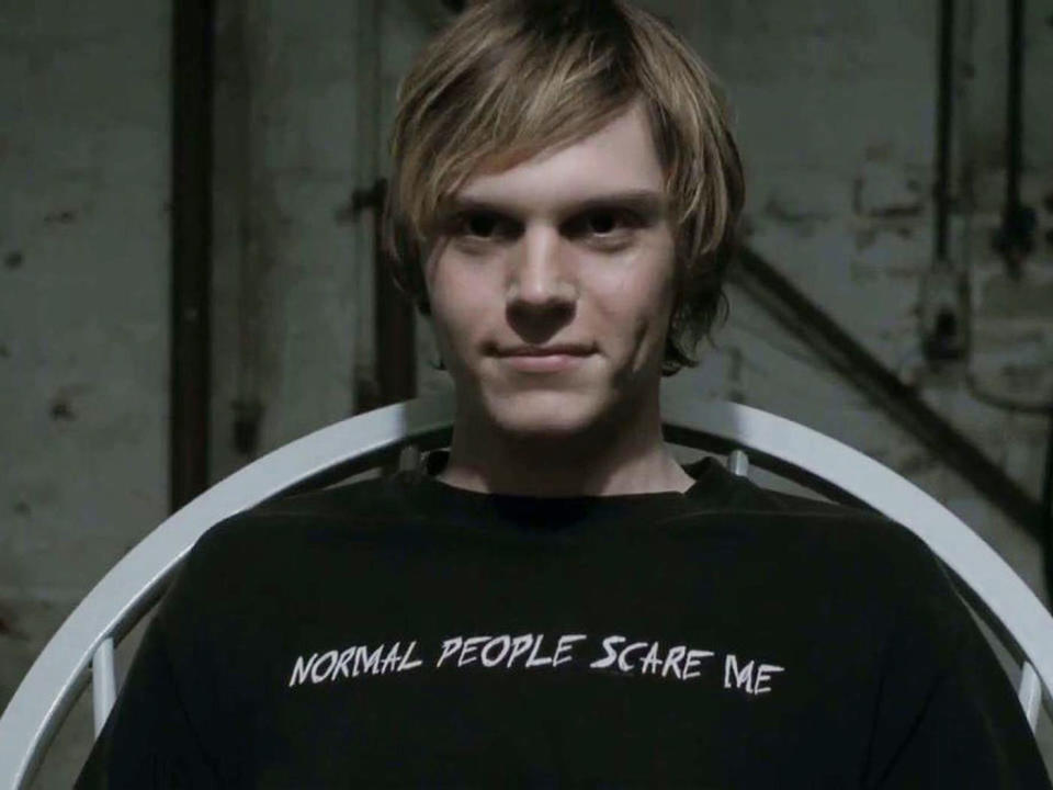 Tate from "American Horror Story" wears a shirt that says, "Normal people scare me"