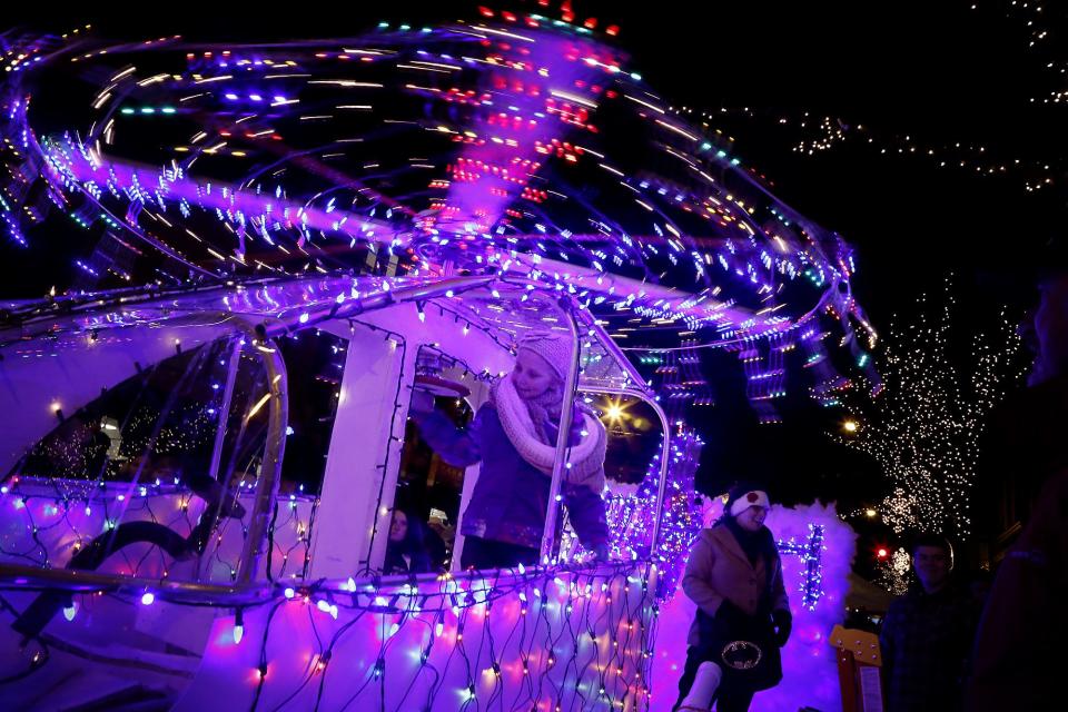 Savannah Niemczyk, of Elmira, spins a helicopter's rotor blades on Guthrie Corning Hospital's float, which took first place in Best of Lights during a past Parade of Lights contest. The float used hundreds of lights and took 60 hours to make.