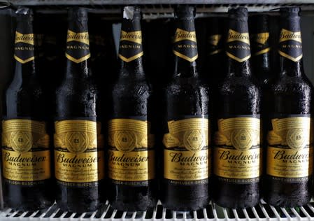 Budweiser beer bottles are seen in a cooler at a liquor shop in Kolkata