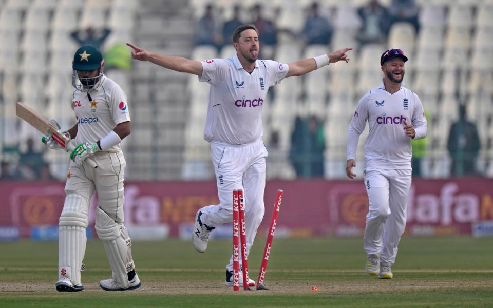 Robinson celebrates/Ollie Robinson struck to remove danger man Babar Azam - AP/ANJUM NAVEED