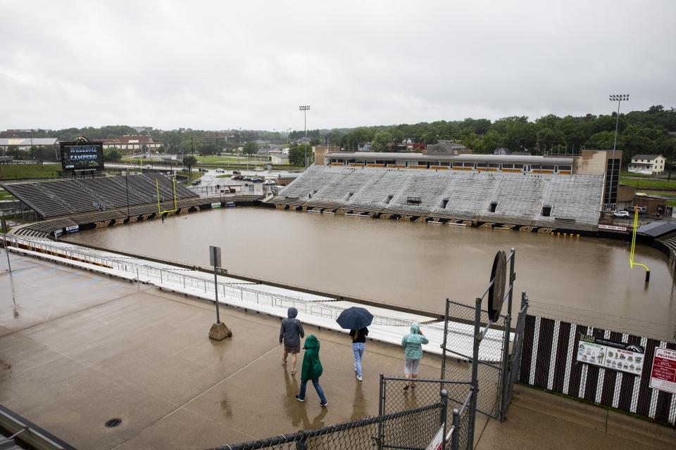 People look at the flooded Waldo Stadium on the campus of Western Michigan University in Kalamazoo, Mich., Thursday, June 20, 2019. (Photo: Joel Bissell/Kalamazoo Gazette via AP)