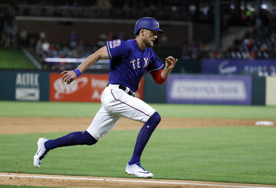 FILE - In this May 21, 2019, file photo, Texas Rangers' Hunter Pence sprints home to score on a Nomar Mazara double in the sixth inning of the team's baseball game against the Seattle Mariners in Arlington, Texas. Pence is returning to the San Francisco Giants, agreeing to a contract that will give the young club a veteran presence in both the outfield and clubhouse in a season of big change ahead. A person with direct knowledge of the deal said Friday, Feb. 7, 2020, that Pence had reached agreement pending a physical. (AP Photo/Tony Gutierrez, File)