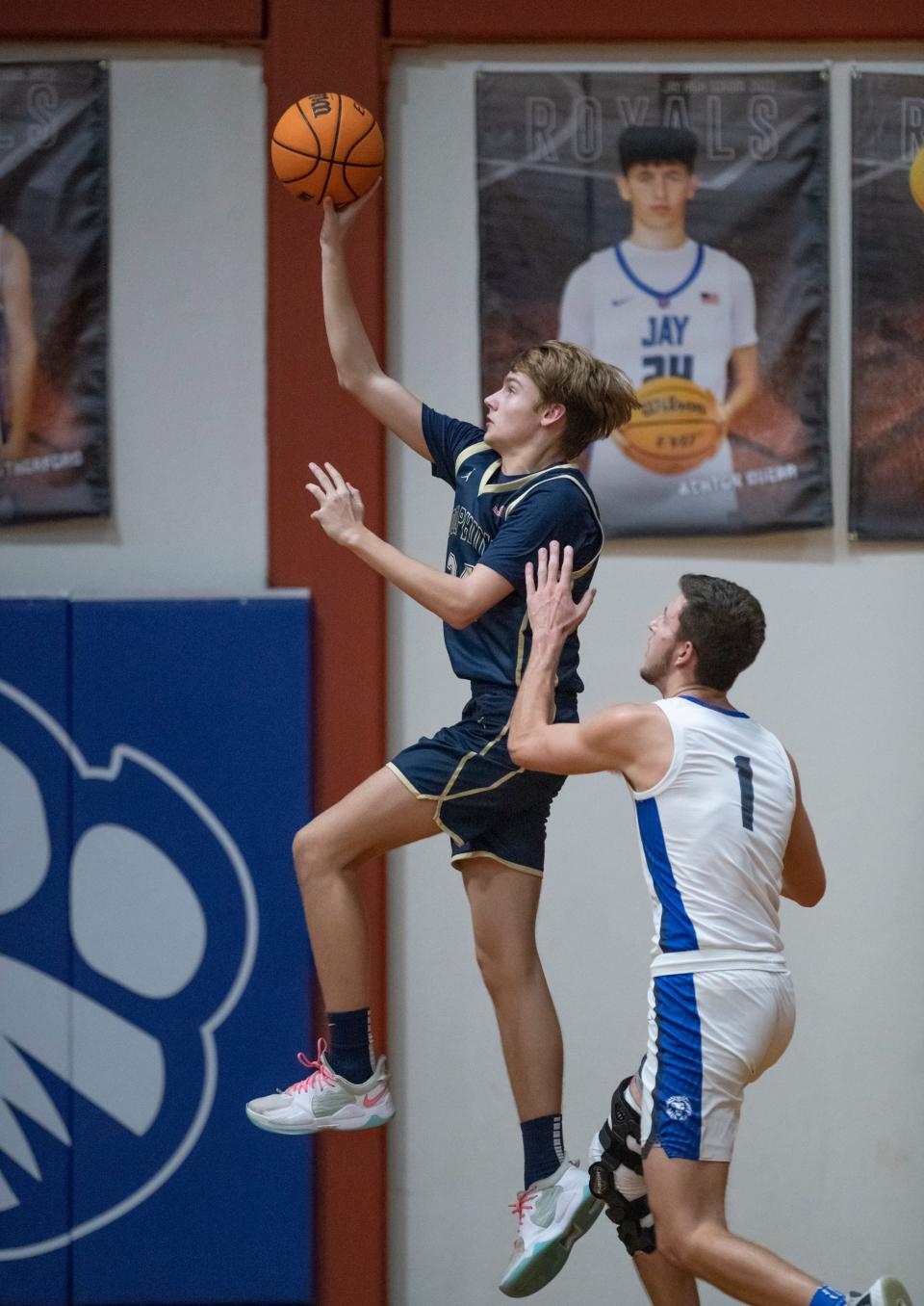 Jack Banks (24) takes it to the hoop during the Gulf Breeze vs Jay boys basketball game at Jay High School on Tuesday, Jan. 18, 2022.