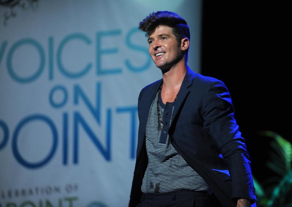 FILE - In this Sept. 15, 2012 publicity photo provided by the Point Foundation, Robin Thicke performs at "Voices On Point" Concert & Gala held at The Wiltern theatre, in Los Angeles. Thicke originally didn't plan to release the unrated version of his music video for the song “Blurred Lines,” which features nude models prowling around him and rappers Pharrell and T.I. Thicke's unrated video hit the Web on Tuesday, March 26, 2013, and so far it has more than 700,000 views. (AP Photo/Point Foundation, Colin Young-Wolff, File)