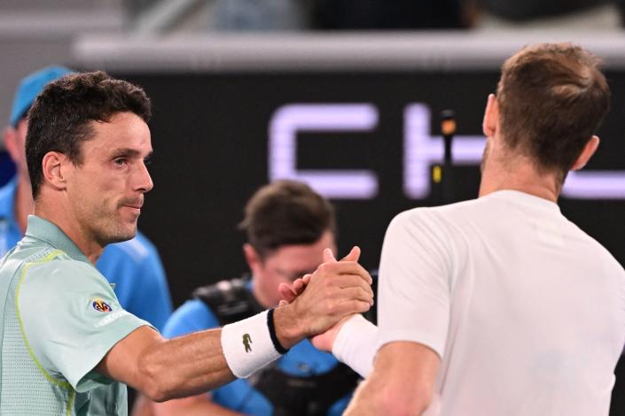 Roberto Bautista Agut (left) greets Andy Murray after winning the third-round match in Melbourne. (Photo by William West/AFP via Getty Images)