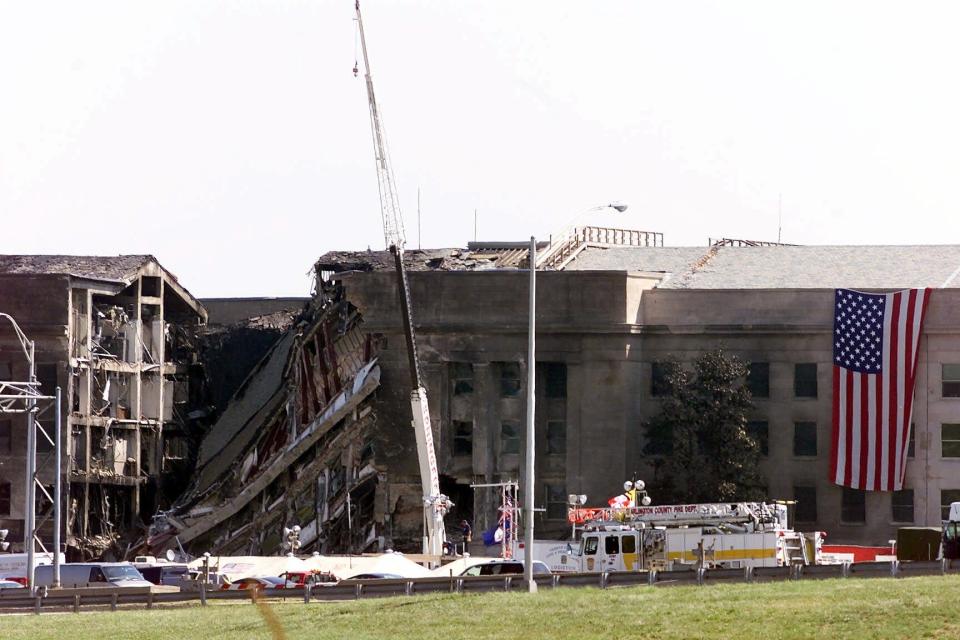 An American flag is draped over the walls of the Pentagon on Sept. 13, 2001, after the 9/11 terrorist attacks. Al-Qaida militants crashed  American Airlines Flight 77 into the Pentagon, killing 184 people.