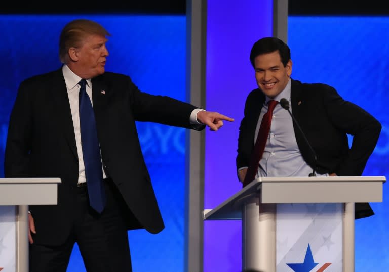 Republican presidential candidate Donald Trump (L) jokes with fellow candidate Marco Rubio(R) during a break in the Republican Presidential Candidates Debate in Manchester, New Hampshire