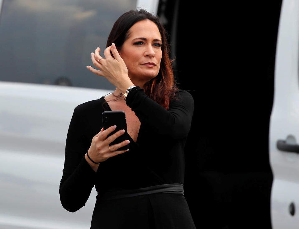 Stephanie Grisham, spokesperson for first lady Melania Trump, waits by a van after her arrival for a Donald Trump campaign rally in Orlando, Fla., on June 18, 2019. (Photo: Carlos Barria/Reuters)