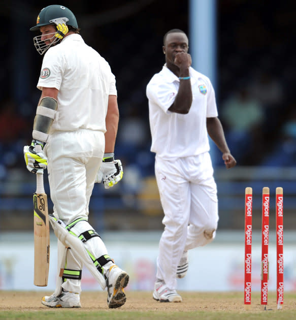 West Indies bowler Kemar Roach (R) celebrates the wicket of Australian batsman Ben Hilfenhausdur (L) during the second day of the second-of-three Test matches between Australia and West Indies April 16, 2012 at Queen's Park Oval in Port of Spain, Trinidad. AFP PHOTO/Stan HONDA