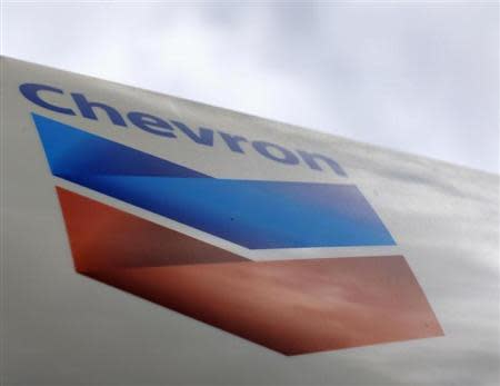 A Chevron gas station sign is pictured at one of their retain gas stations in Cardiff, California October 9, 2013. REUTERS/Mike Blake