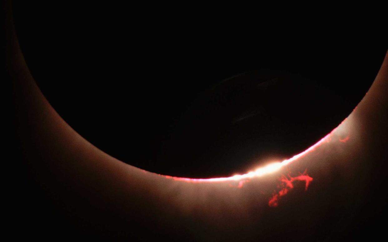 A close-up view of the Sun's disk during a total eclipse reveals fiery solar prominences. | View from: Mauna Kea Science Reserve.   (Photo by Roger Ressmeyer/Corbis/VCG via Getty Images)