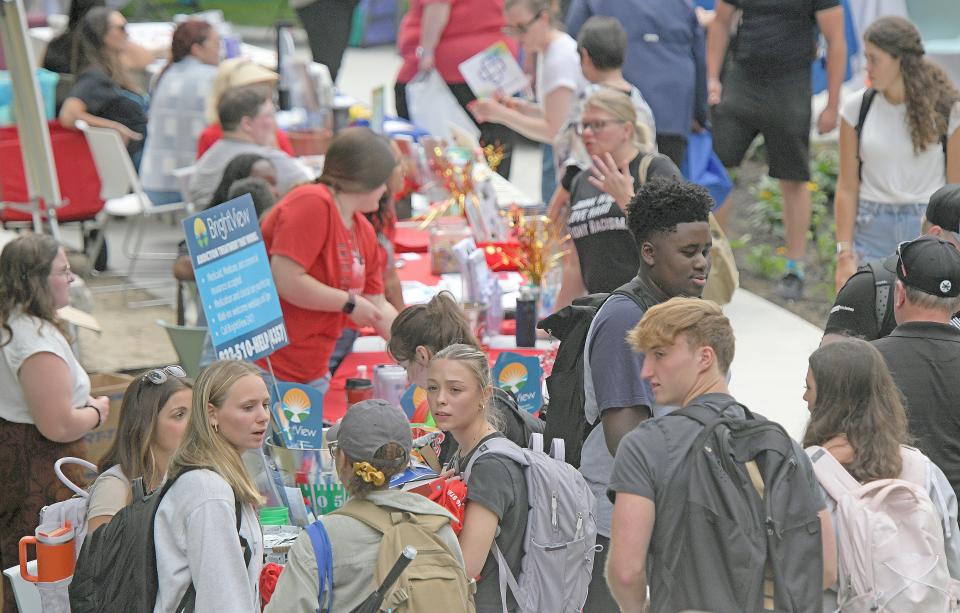 Students walk through The Ohio State University Mansfield/North Central State College Involvement and Community Fair on Wednesday afternoon.