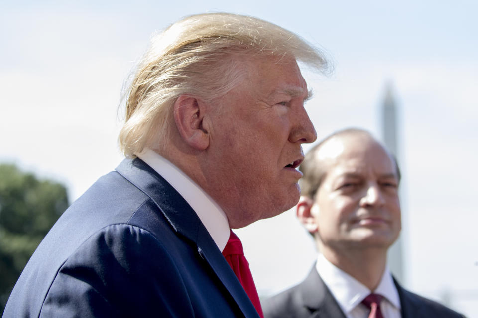 President Donald Trump, accompanied by Labor Secretary Alex Acosta, right, speaks to members of the media on the South Lawn of the White House in Washington, Friday, July 12, 2019, before Trump boards Marine One for a short trip to Andrews Air Force Base, Md. and then on to Wisconsin. Trump says Labor Secretary Alex Acosta to step down, move comes in wake of handling of Jeffrey Epstein case. (AP Photo/Andrew Harnik)