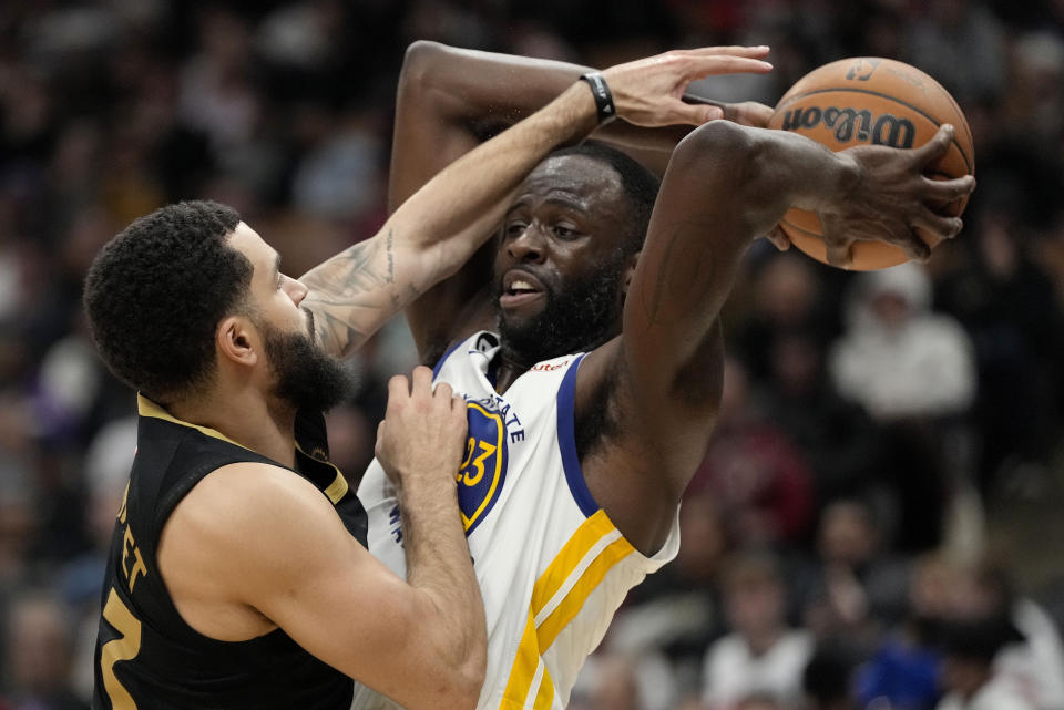 Toronto Raptors guard Fred VanVleet fouls Golden State Warriors forward Draymond Green during the second half of an NBA basketball game in Toronto, Sunday, Dec. 18, 2022. (Frank Gunn/The Canadian Press via AP)