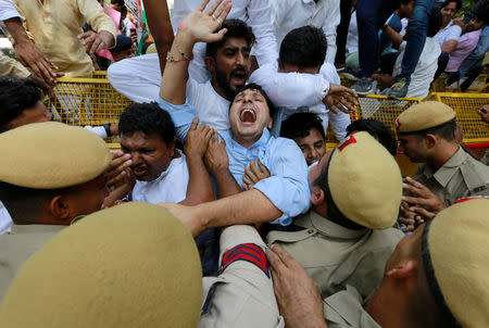 Supporters of India's main opposition Congress party scuffle with police during a protest demanding the resignation of India's Minister of State for External Affairs Mobashar Jawed Akbar in New Delhi, India, October 15, 2018. REUTERS/Adnan Abidi