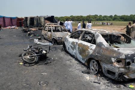 Burnt out cars and motorcycles are seen at the scene of an oil tanker explosion in Bahawalpur, Pakistan June 25, 2017. REUTERS/Stringer