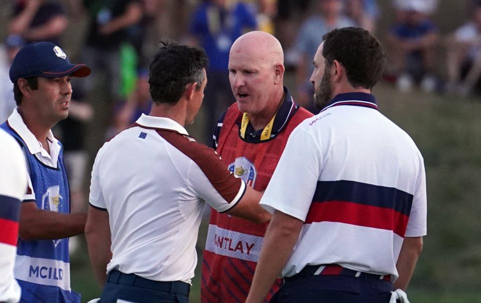 Team Europe's Rory McIlroy argues with Joe LaCava, caddie of USA's Patrick Cantlay on the 18th following the fourballs