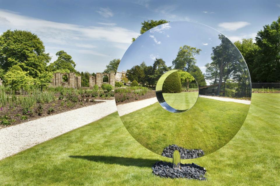 This photo shows British designer David Harber's Torus sculpture. The sculpture is crafted of highly polished steel, and can be made in different sizes. The striking effect: reflections of Torus' surrounding environment – grass, trees or water – seem to make the piece transparent. (Clive NicholsDavid Harper via AP)