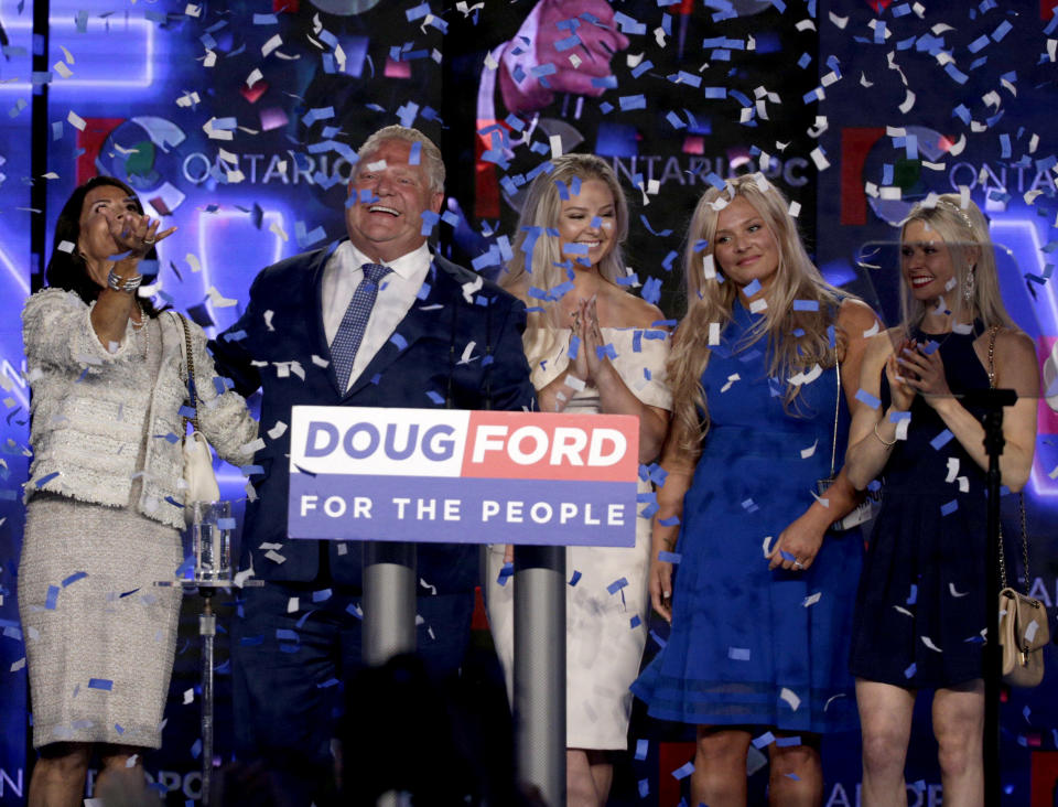 Ontario PC Leader Doug Ford smiles with his wife and three daughters after winning the provincial election on June 7, 2018. Photo from Getty Images.
