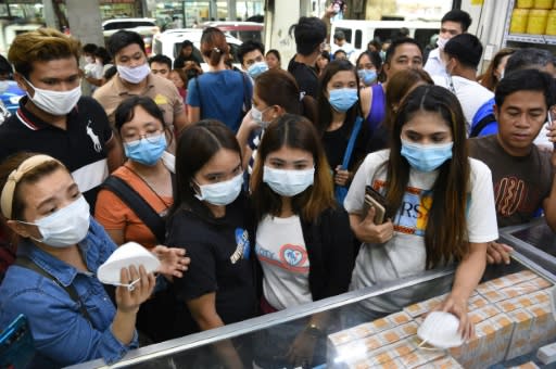 Anxious shoppers try to buy face masks in Manila after the first foreign fatality from the new coronavirus was reported in the Philippines