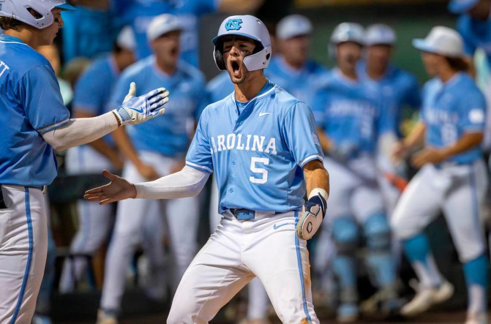 North Carolina third baseman Gavin Gallaher (5) celebrates at home plate with Vance Honeycutt (7) after scoring on a base hit by short stop Colby Wilkerson to tie LSU 3-3 in the ninth inning and force extra innings during the NCAA Regional final on Monday, June 3, 2024 at Boshamer Stadium in Chapel Hill, N.C.