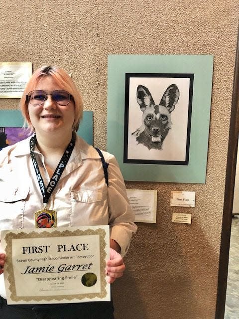 Jamie Garrett with her first-place certificate and winning art work at a countywide contest for Beaver County students.