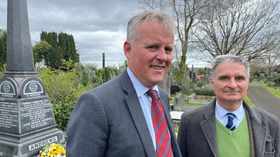 Two descendants of Professor Thomas Andrews pictured at his grave.